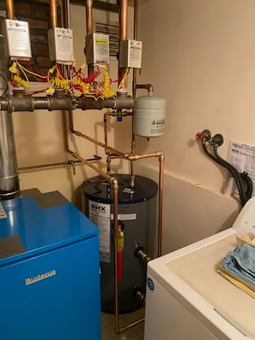 Buderus boiler with Bock water heater and zone valves in a Long Island laundry room