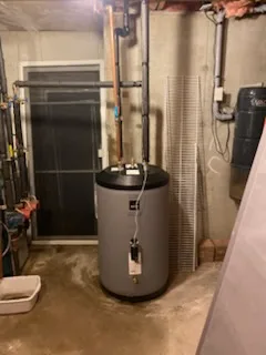Indirect hot water tank installed in a basement