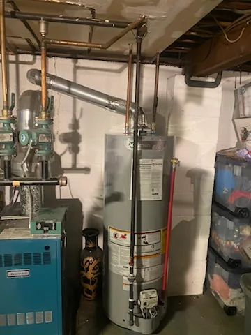 A.O. Smith water heater next to a cast-iron boiler