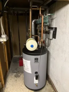 Indirect hot water tank installed in a narrow basement
