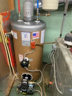 Oil-fired water heater installed with new burner and piping